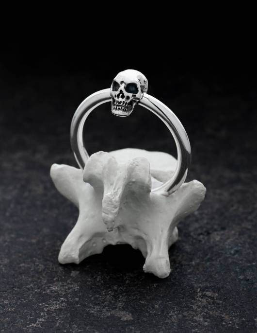 A handmade silver skull ring on a bone from KIPKALINKA