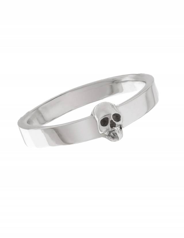 A slim and simple goth wedding band with a detailed skull made of sterling silver.