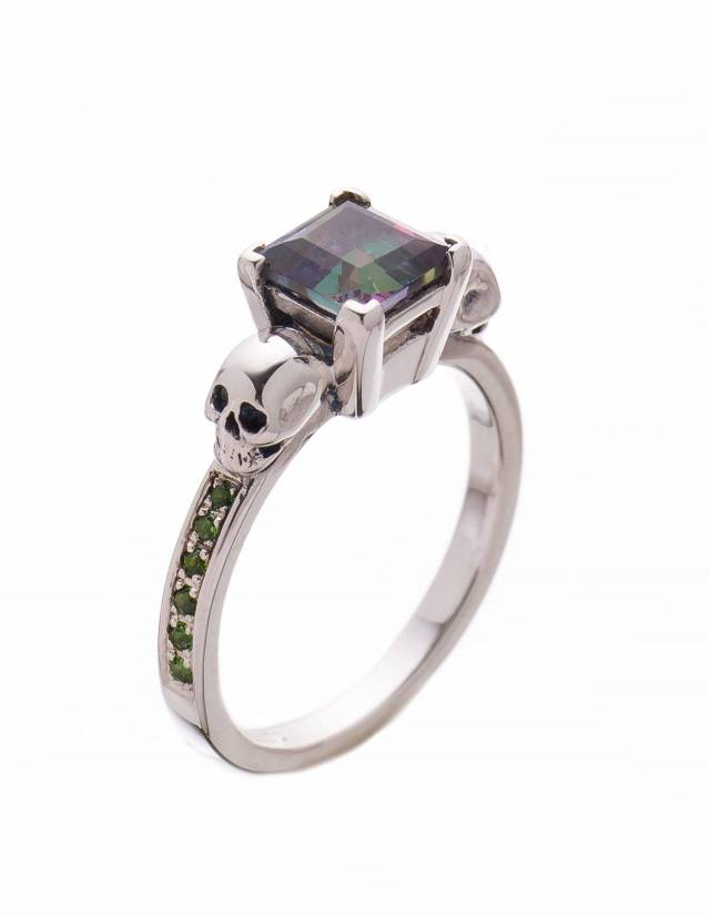 A silver small skull ring with green gemstones from Kipkalinka.
