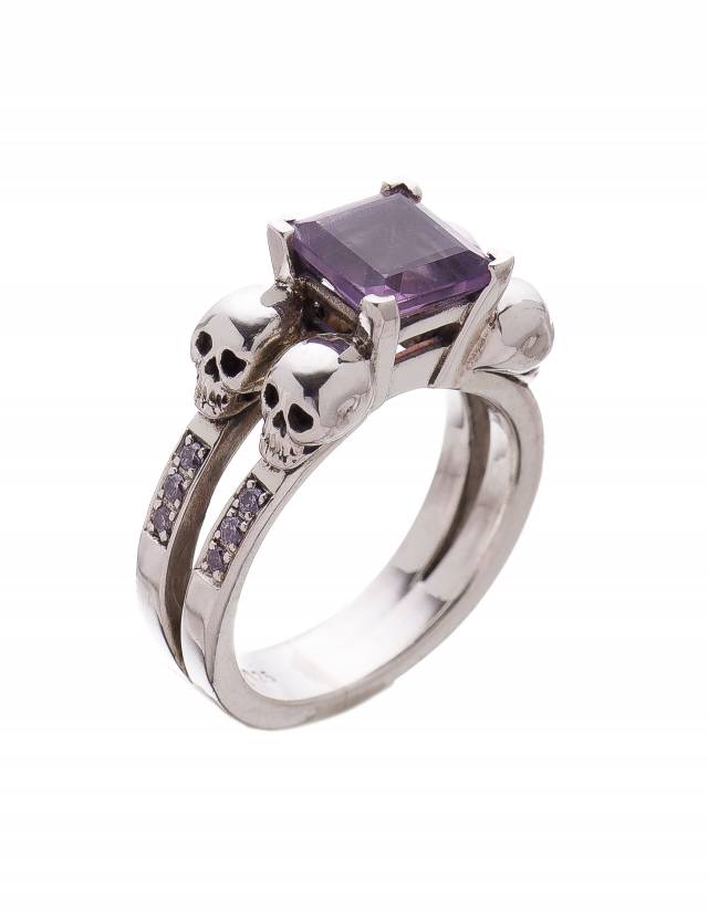 4 skull engagement ring with square purple gemstone.