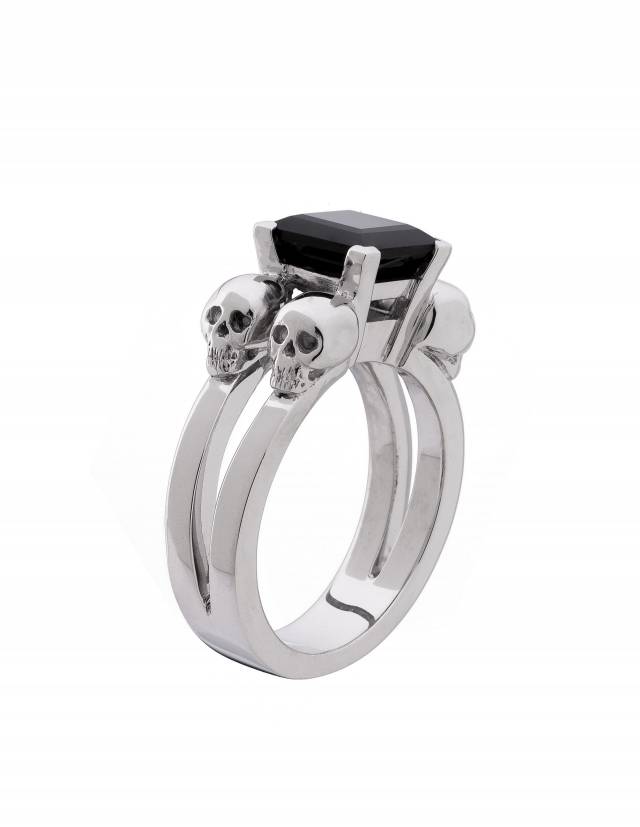 Solid silver goth ring with a black, princess cut gemstone on white background.
