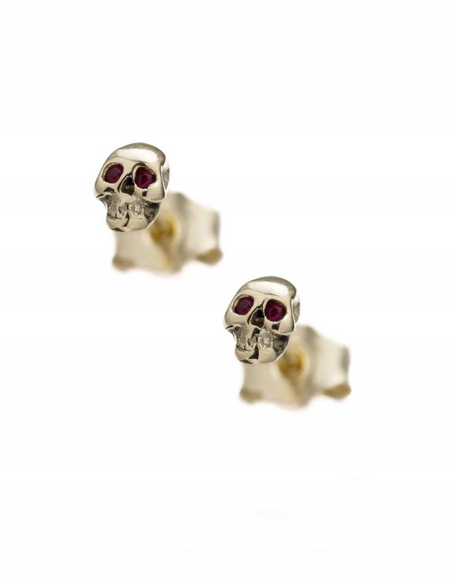 Detailed skull earrings in solid 14k gold with rubies in the eyes.