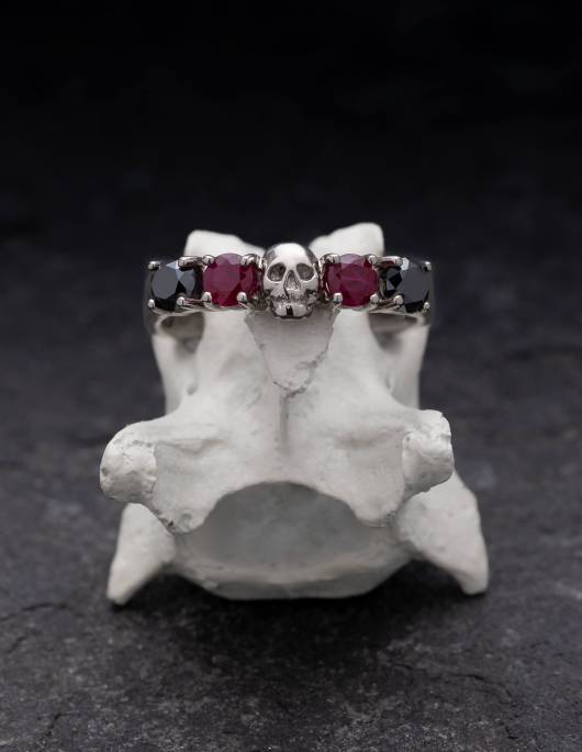 Skull wedding ring made of solid white gold with rubys and natural black diamonds.